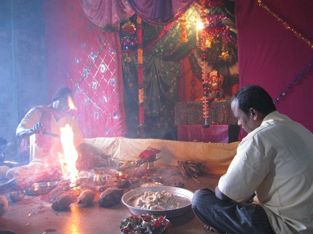 A school in an Adivasi village. A Brahman priest and a school teacher perform a fire sacrifice for the Hindu goddess Saraswati. The classroom has temporarily been converted into a Hindu temple. Local Indigenous deities or practices are not considered important (photo by Peter Berger, 2010)